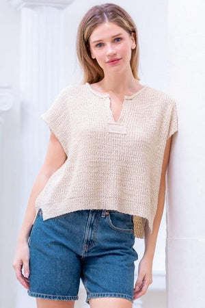 Woman wearing a beige textured top 