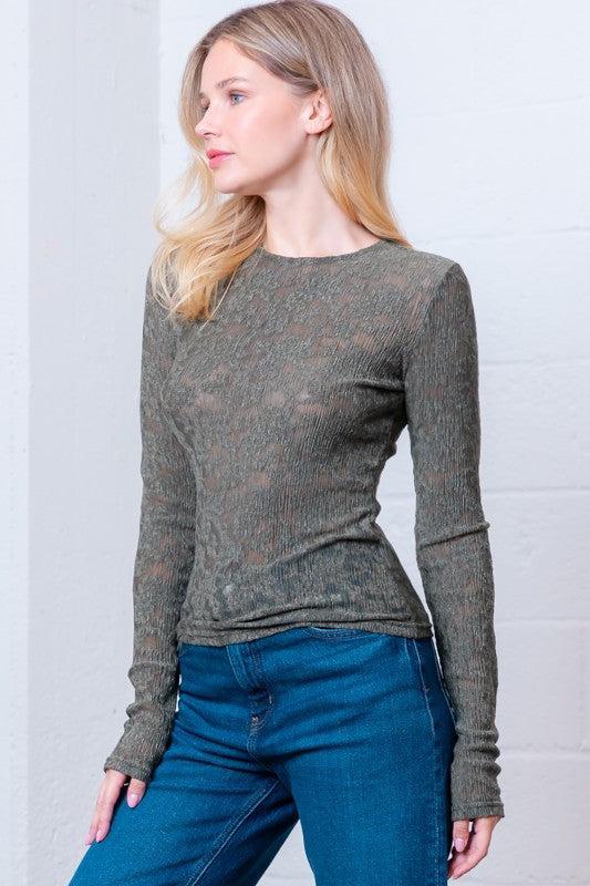 Woman wearing a green patterned long-sleeve top 