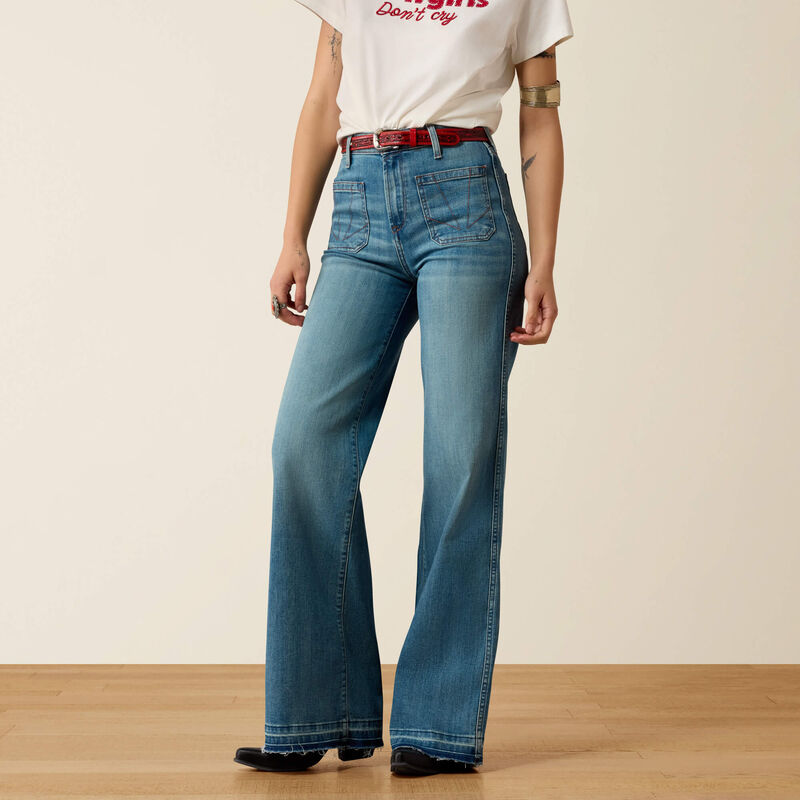 A model wearing high-waisted, wide-leg blue jeans 