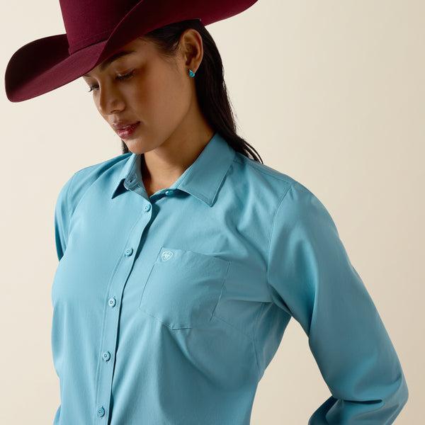 A woman modeling a light blue long-sleeve western button-up shirt  