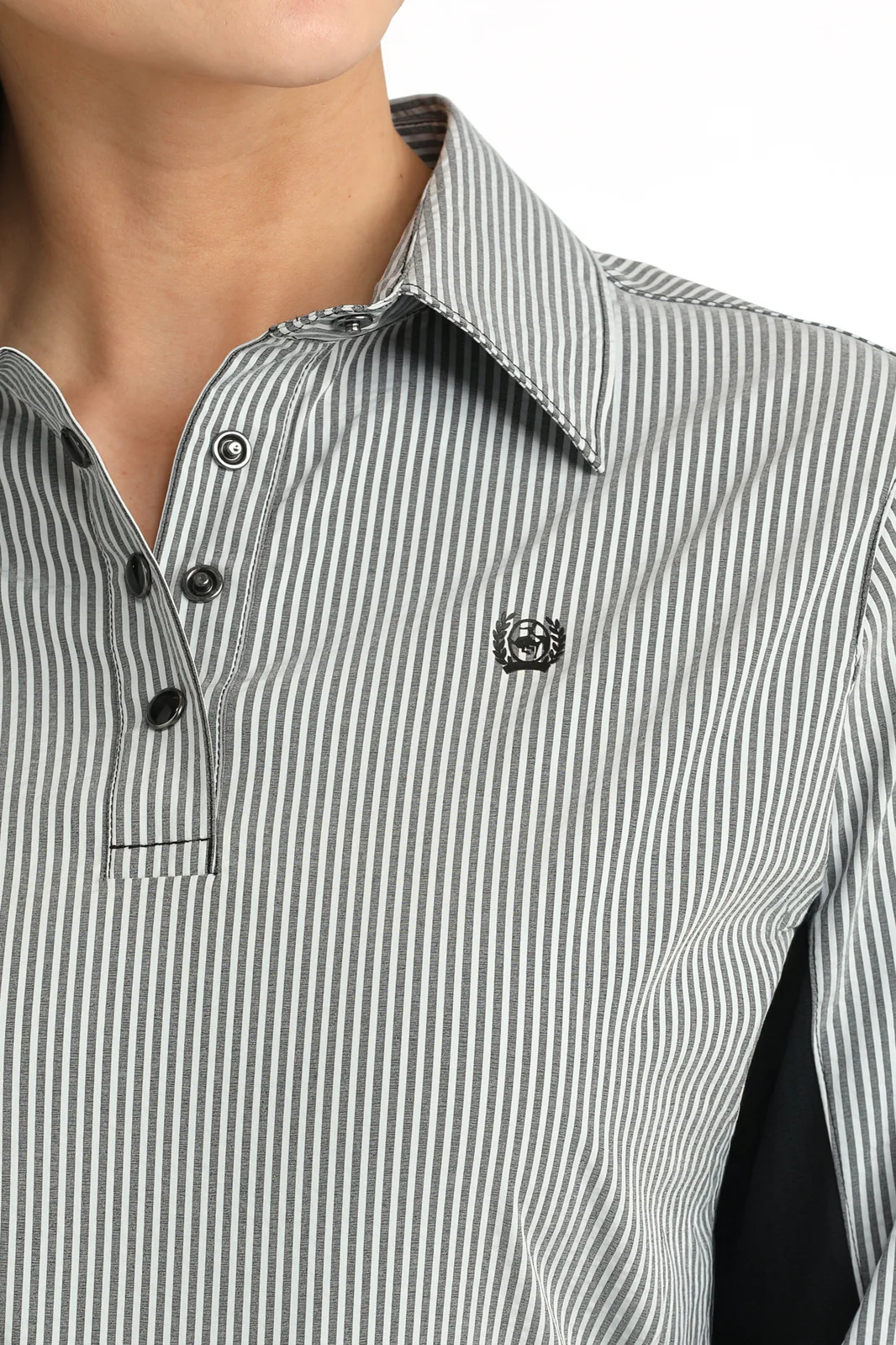 Close-up of a person wearing a black and white striped shirt with a collar.