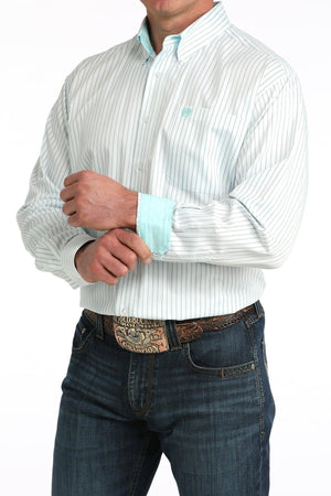 Man wearing a white striped shirt with rolled-up sleeves and blue jeans on a white background