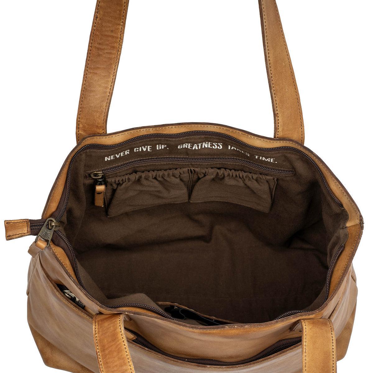 Brown leather handbag with visible interior and text on a white background