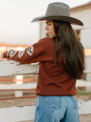 Woman wearing an Aztec patterned sweater