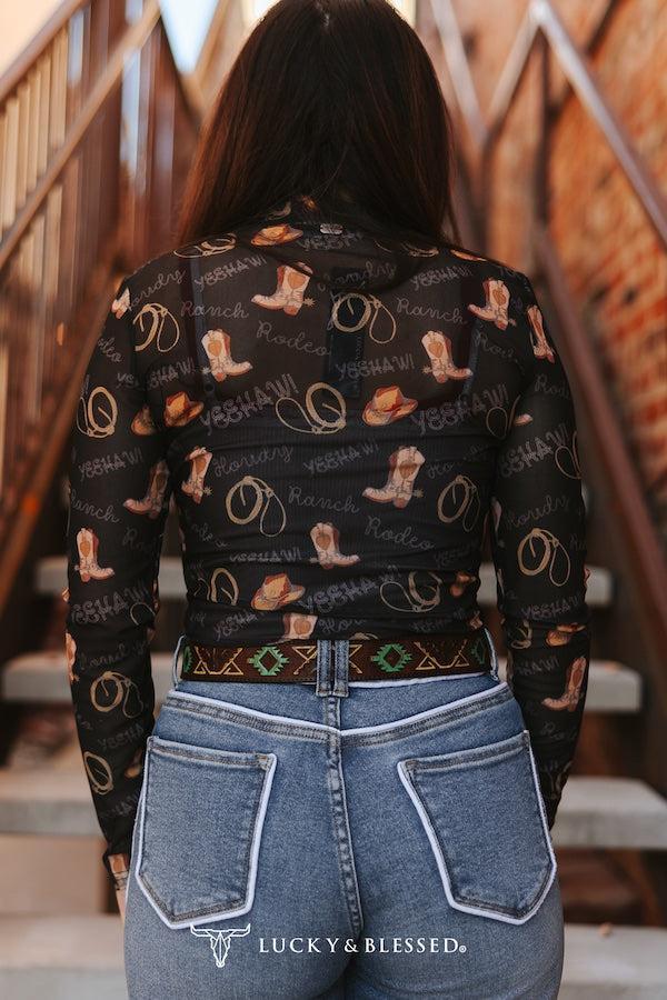 Person wearing a black shirt with cowboy pattern 