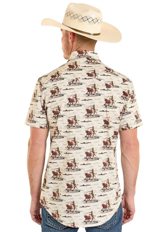 Man wearing a cream-colored short-sleeve shirt with cowboy pattern and a beige cowboy hat on a white background