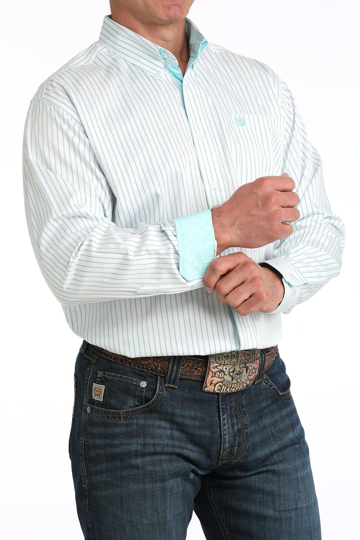Man wearing a white dress shirt with light blue accents and jeans on a white background