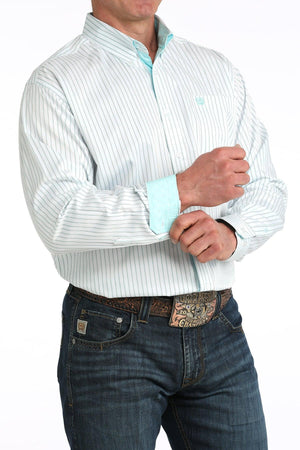 Man wearing a white dress shirt with light blue accents and jeans on a white background
