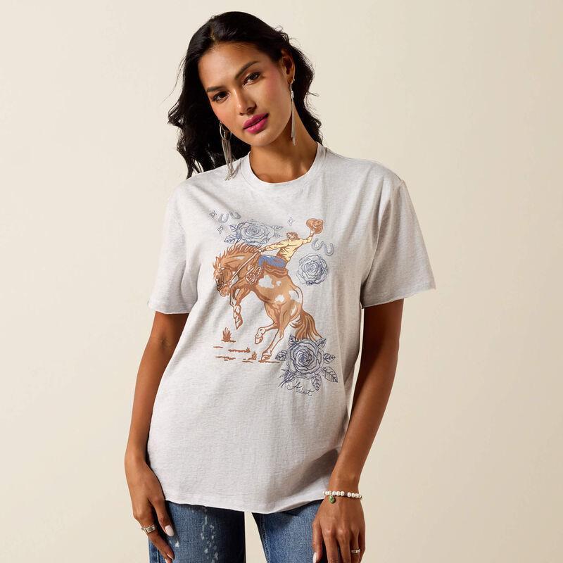 Woman wearing a white t-shirt with a graphic design on a beige background